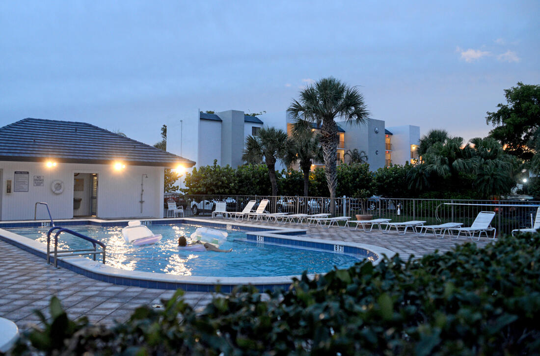 1605 Highway 1, Unit D301 Jupiter, FL 33477 - Photo 29 of 29 a view of a swimming pool with outdoor seating and plants