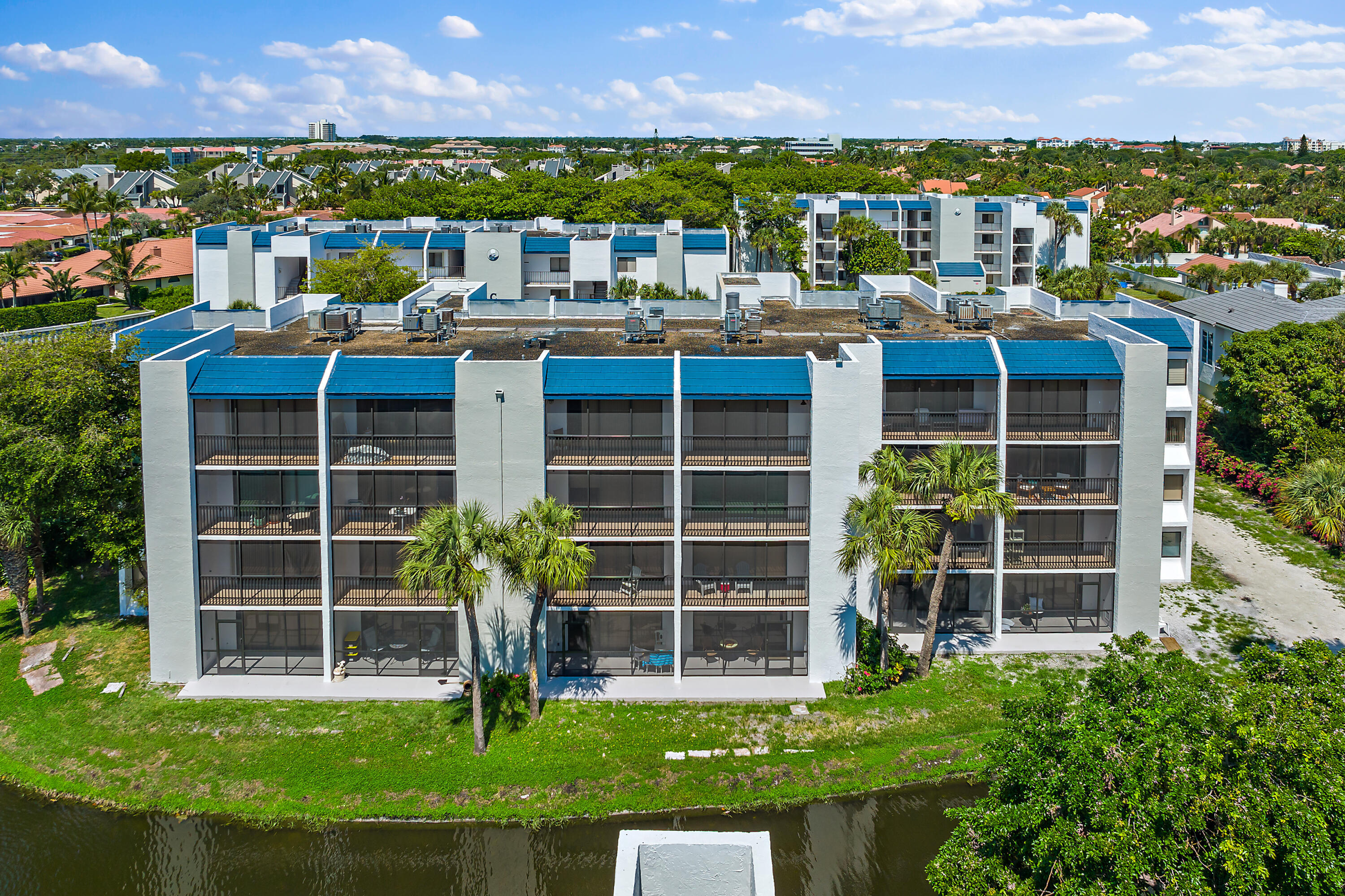 1605 Highway 1, Unit D301 Jupiter, FL 33477 - Photo 4 of 29 a front view of building with yard and outdoor seating