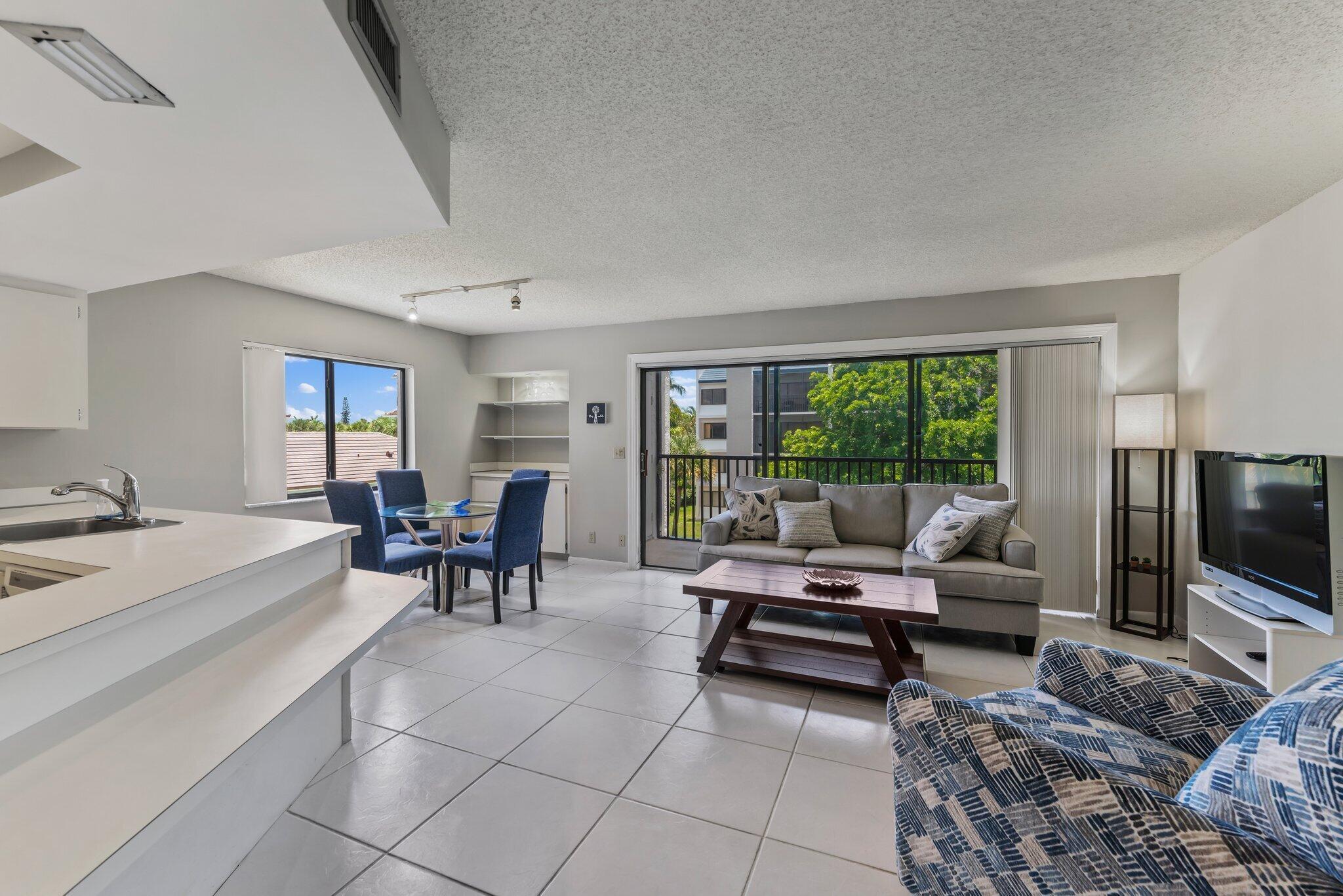 1605 Highway 1, Unit D301 Jupiter, FL 33477 - Photo 7 of 29 a living room with furniture and a flat screen tv