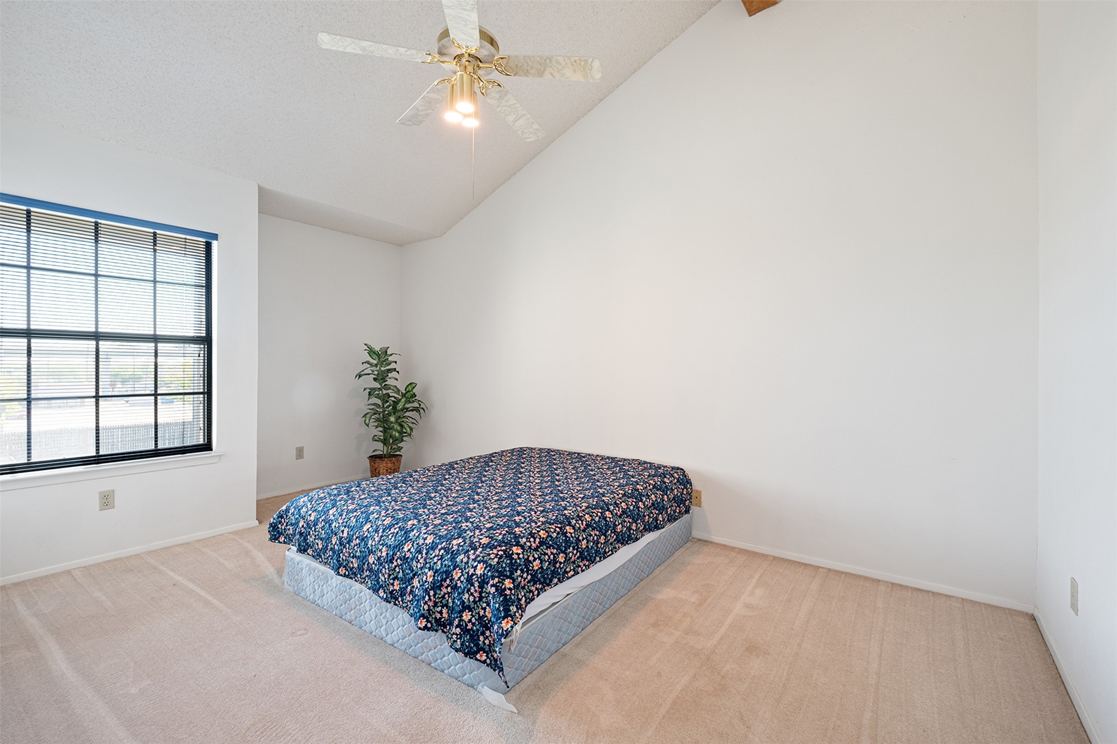 1748 Ohlen Road, Unit 16 Austin, TX 78757 - Photo 25 of 38 Bedroom with light carpet, vaulted ceiling, and ceiling fan