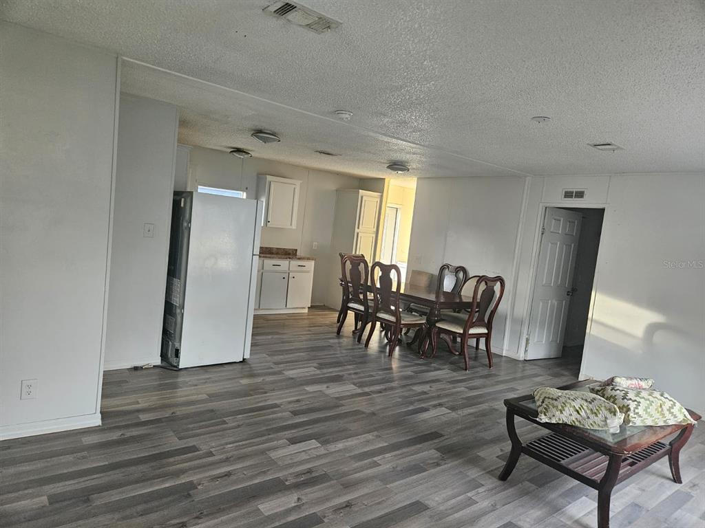 129 4th Street Orlando, FL 32824 - Photo 4 of 27 a view of a dining room with furniture and wooden floor