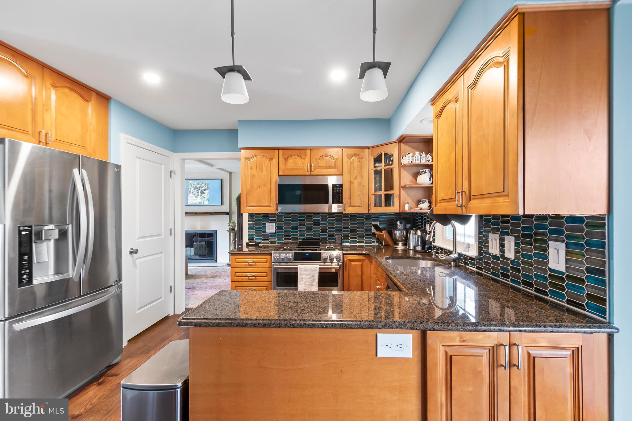 8816 Arley Drive Springfield, VA 22153 - Photo 16 of 59 a kitchen with stainless steel appliances granite countertop a sink a stove and a refrigerator