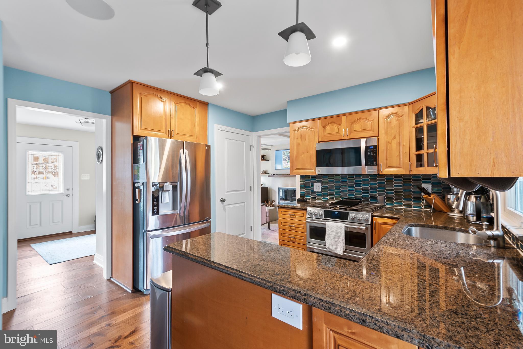 8816 Arley Drive Springfield, VA 22153 - Photo 17 of 59 a kitchen with stainless steel appliances granite countertop a sink a stove and a wooden floors