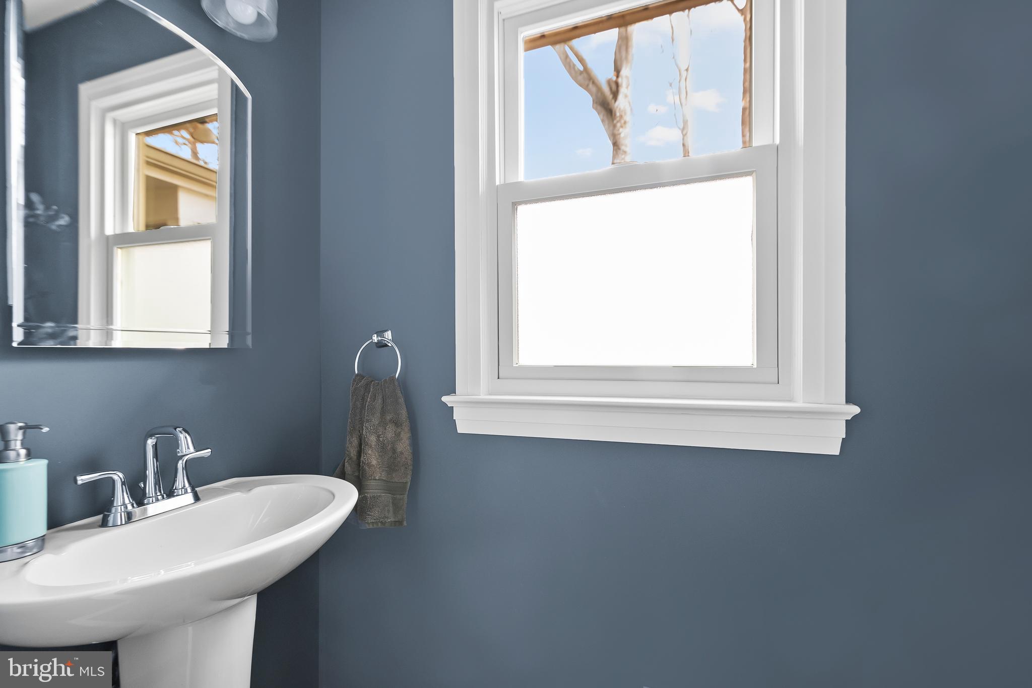 8816 Arley Drive Springfield, VA 22153 - Photo 21 of 59 a bathroom with a sink a mirror and a window