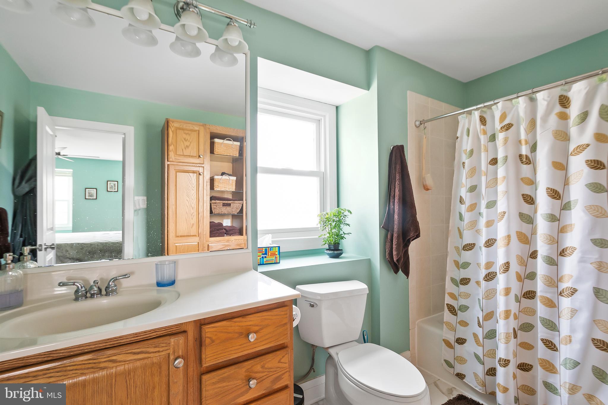 8816 Arley Drive Springfield, VA 22153 - Photo 31 of 59 a bathroom with a granite countertop toilet a sink a mirror a window and tub