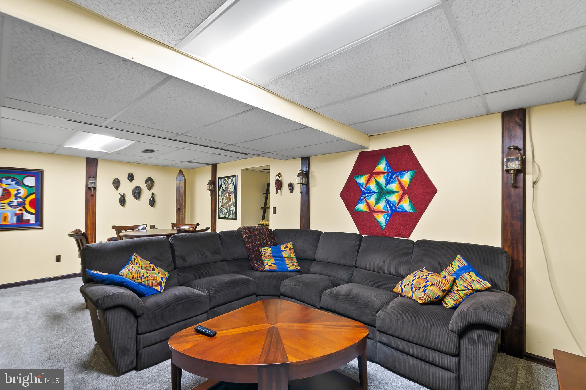 8816 Arley Drive Springfield, VA 22153 - Photo 40 of 59 a living room with furniture and wall paintings