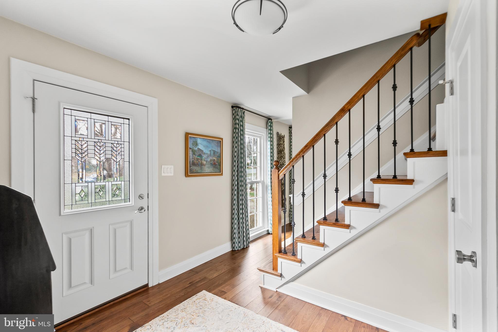 8816 Arley Drive Springfield, VA 22153 - Photo 6 of 59 a view of an entryway with wooden floor and stairs