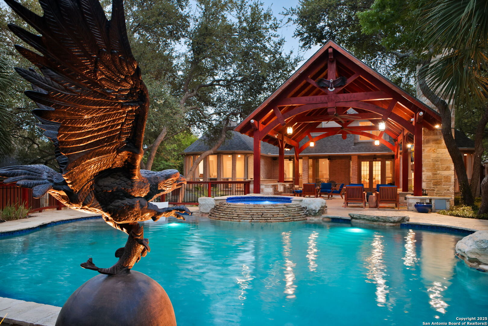 a view of a lake with couches and chairs under an umbrella
