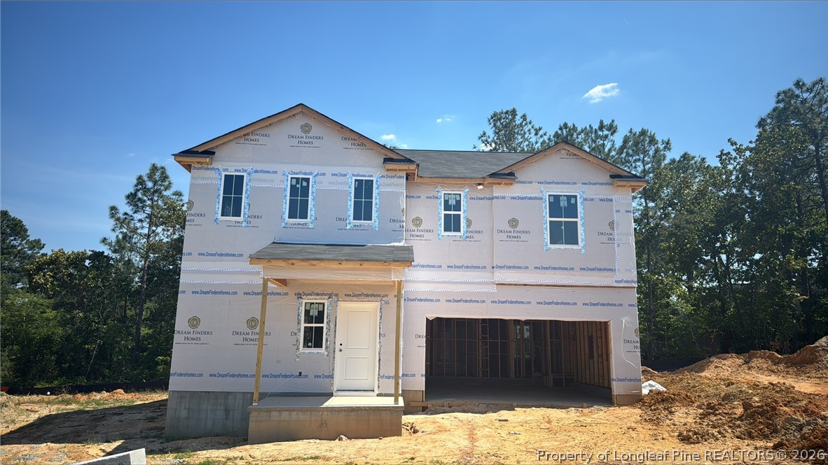 114 Colorado Court Spring Lake, NC 28390 - Photo 1 of 4 a front view of a house with a yard and garage