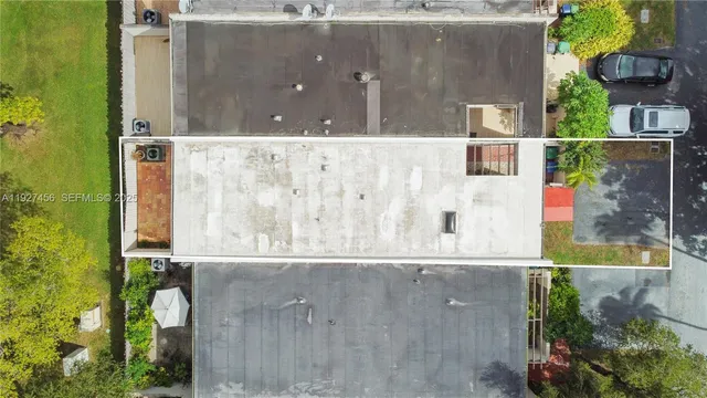 an aerial view of residential houses with outdoor space