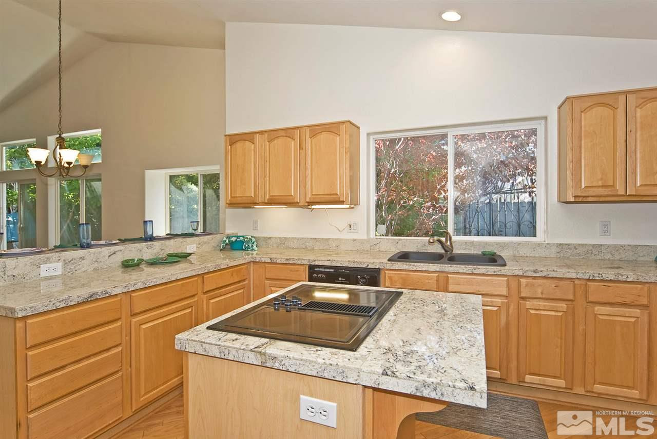6030 Sunrise Meadows Loop Reno, NV 89519 - Photo 11 of 22 a kitchen with granite countertop a sink a counter space and cabinets