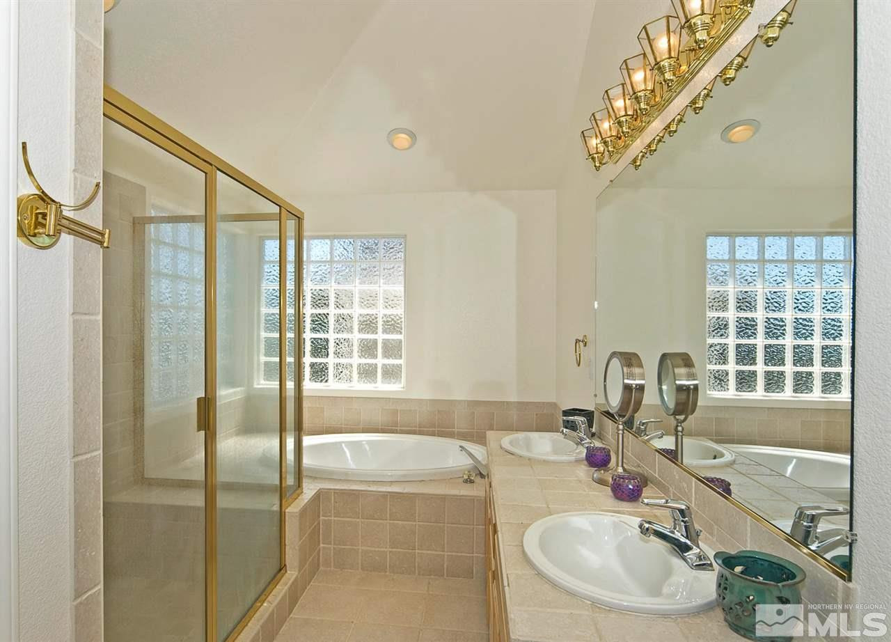 6030 Sunrise Meadows Loop Reno, NV 89519 - Photo 17 of 22 a bathroom with a tub sink and mirror