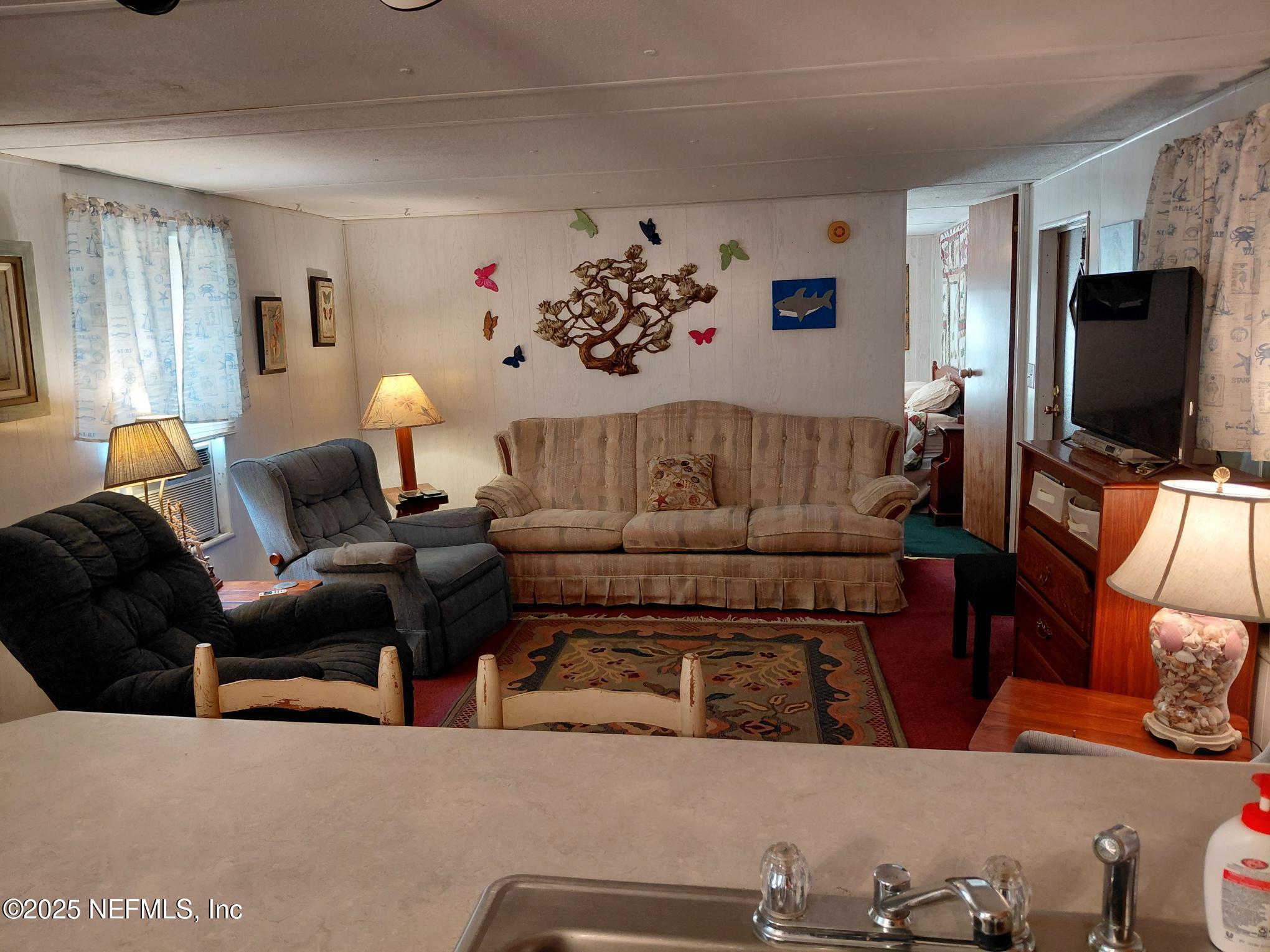 110 Glenside Street Georgetown, FL 32139 - Photo 11 of 18 a living room with furniture and a flat screen tv