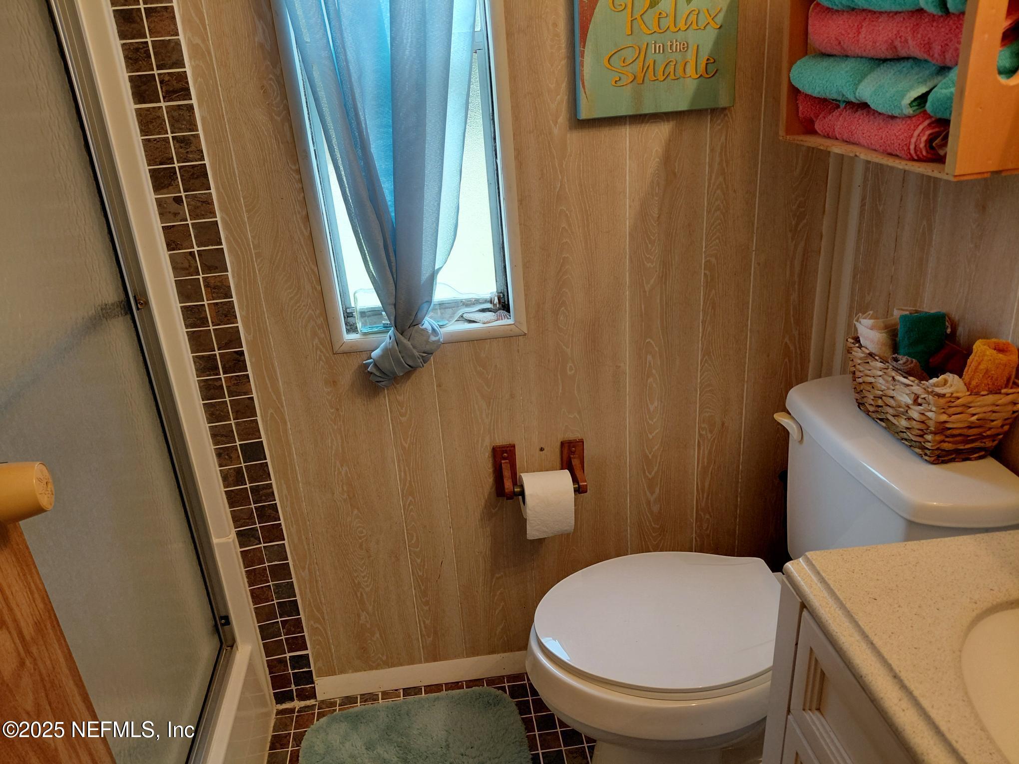 110 Glenside Street Georgetown, FL 32139 - Photo 12 of 18 a bathroom with a toilet and a shower curtain