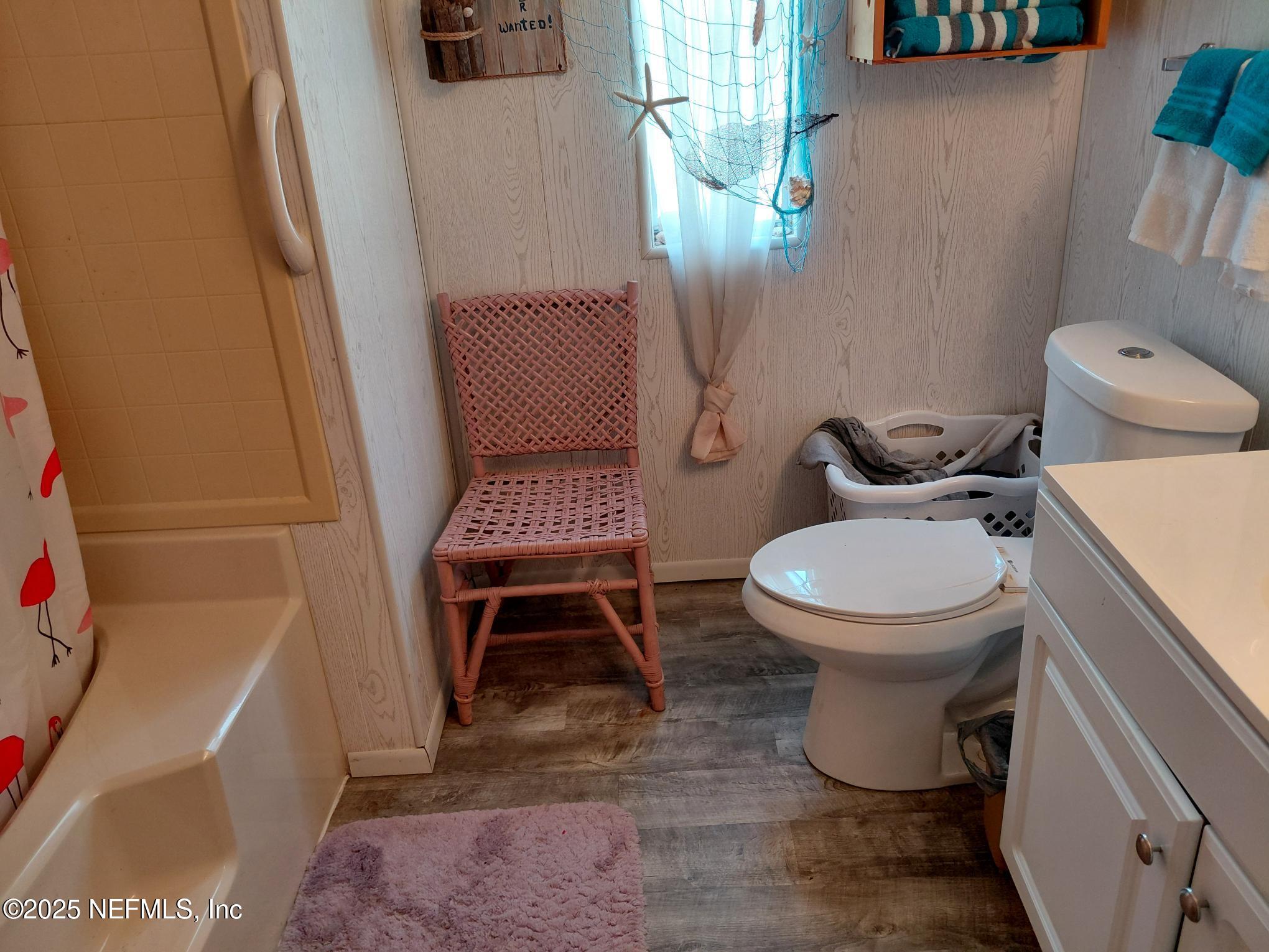 110 Glenside Street Georgetown, FL 32139 - Photo 16 of 18 a white toilet sitting next to a bathroom sink and a mirror