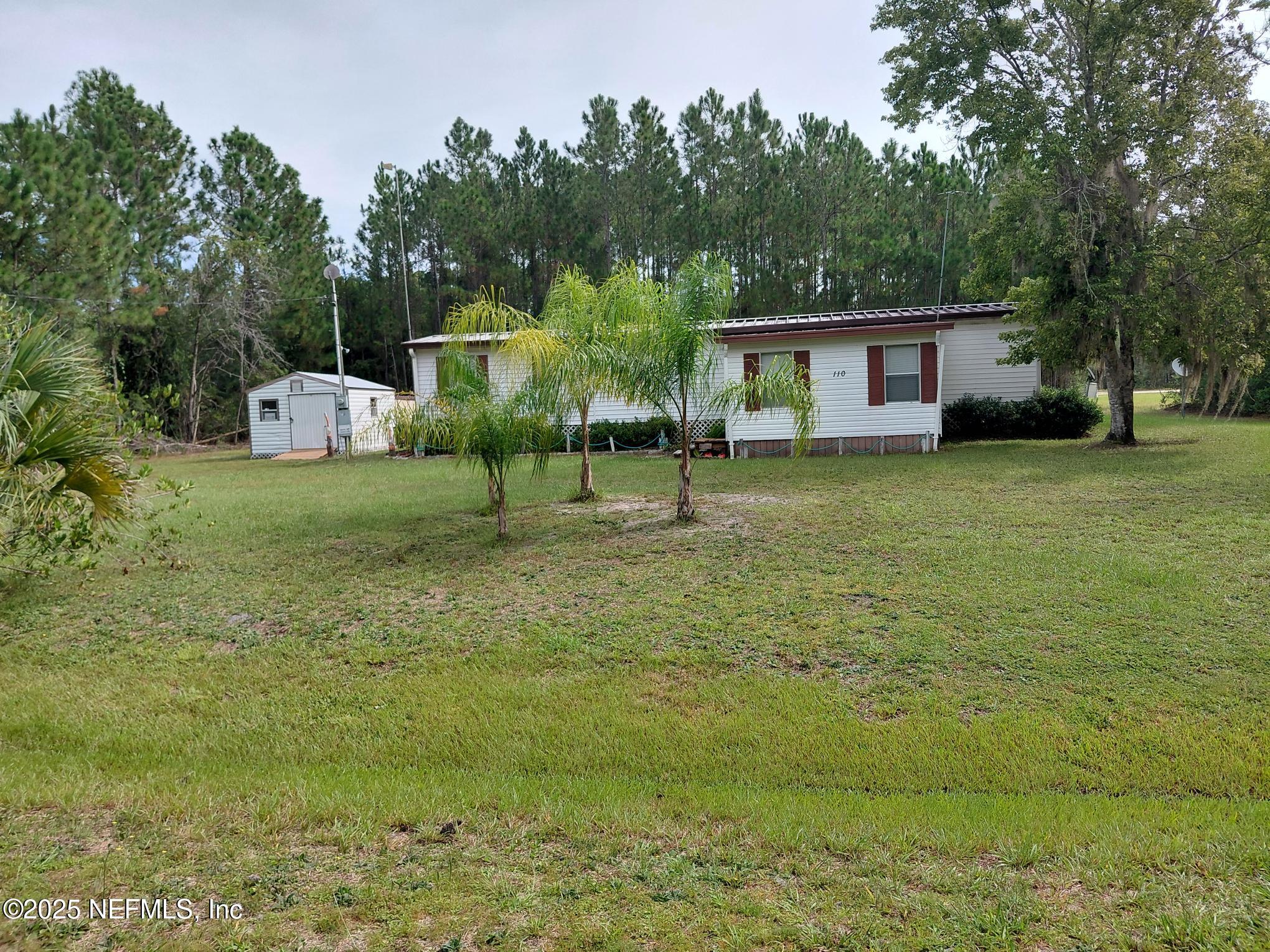 110 Glenside Street Georgetown, FL 32139 - Photo 2 of 18 a front view of a house with garden