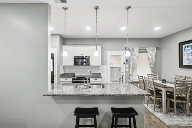 a large kitchen with a table and chairs