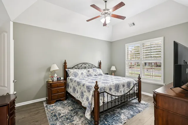 a bedroom with a bed and a chandelier