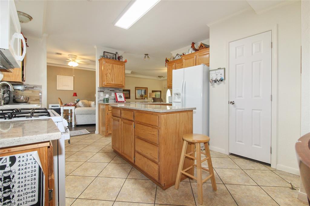 455 Hughes Cemetery Road Italy, TX 76651 - Photo 12 of 40 a kitchen with cabinets and chairs