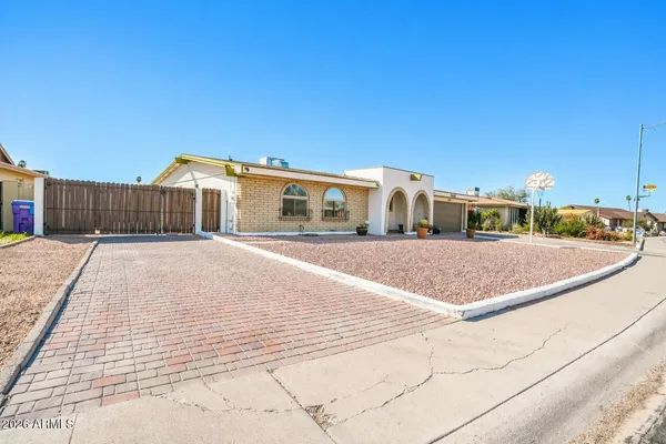 a view of house with yard and car parked
