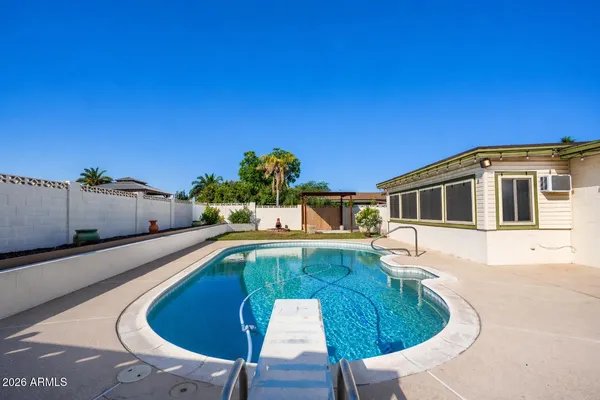 a swimming pool with outdoor seating