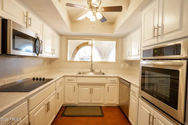 a kitchen with a sink stove and microwave