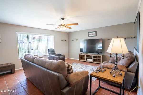 a living room with furniture a large window and a flat screen tv