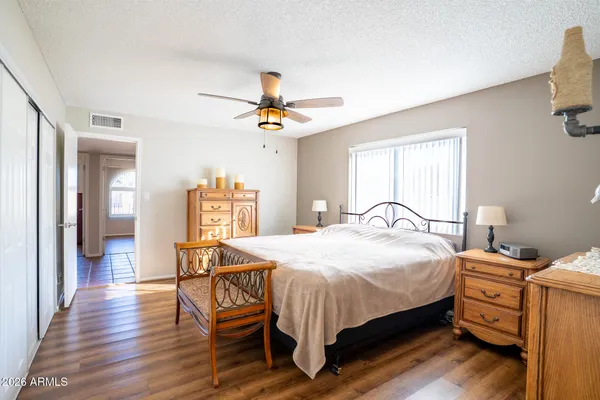 a bedroom with a bed and wooden floor