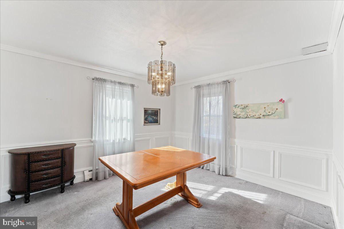 1449 Burmont Road Drexel Hill, PA 19026 - Photo 11 of 27 a living room with furniture a chandelier and a window