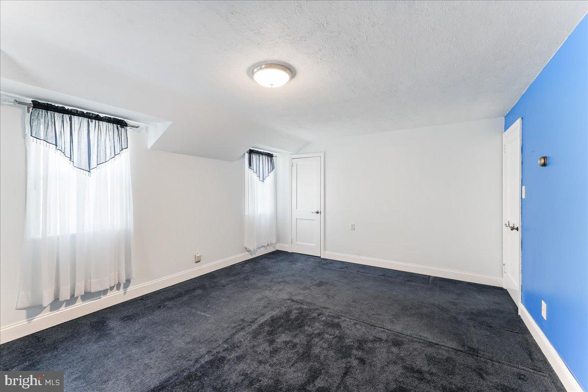 1449 Burmont Road Drexel Hill, PA 19026 - Photo 14 of 27 an empty room with cabinet and stairs