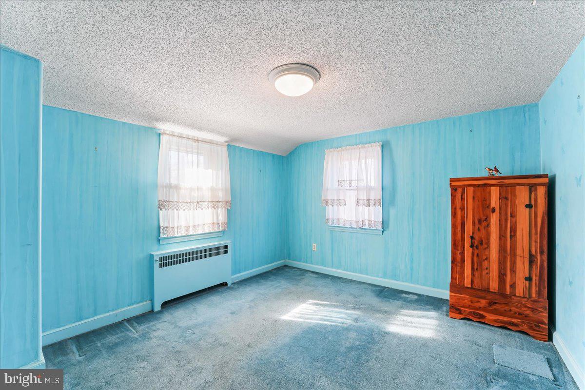 1449 Burmont Road Drexel Hill, PA 19026 - Photo 16 of 27 an empty room with windows cabinet and front door