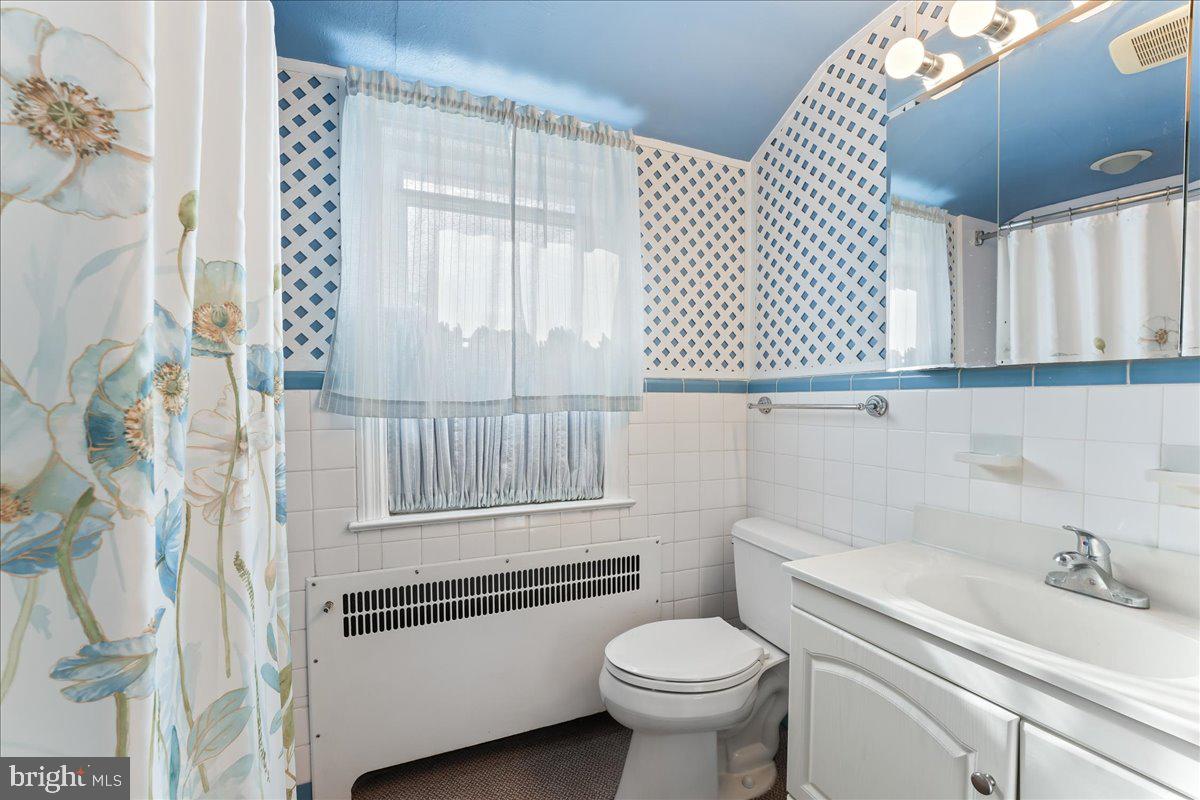 1449 Burmont Road Drexel Hill, PA 19026 - Photo 18 of 27 a bathroom with a sink a toilet and a shower