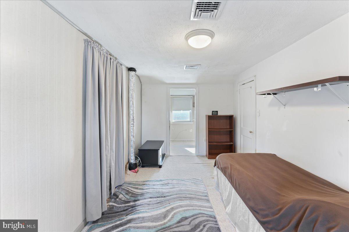 1449 Burmont Road Drexel Hill, PA 19026 - Photo 19 of 27 a bedroom with a bed and a television