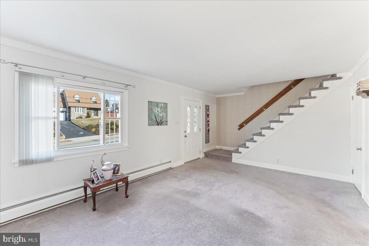 1449 Burmont Road Drexel Hill, PA 19026 - Photo 3 of 27 a view of an empty room with stairs and a window