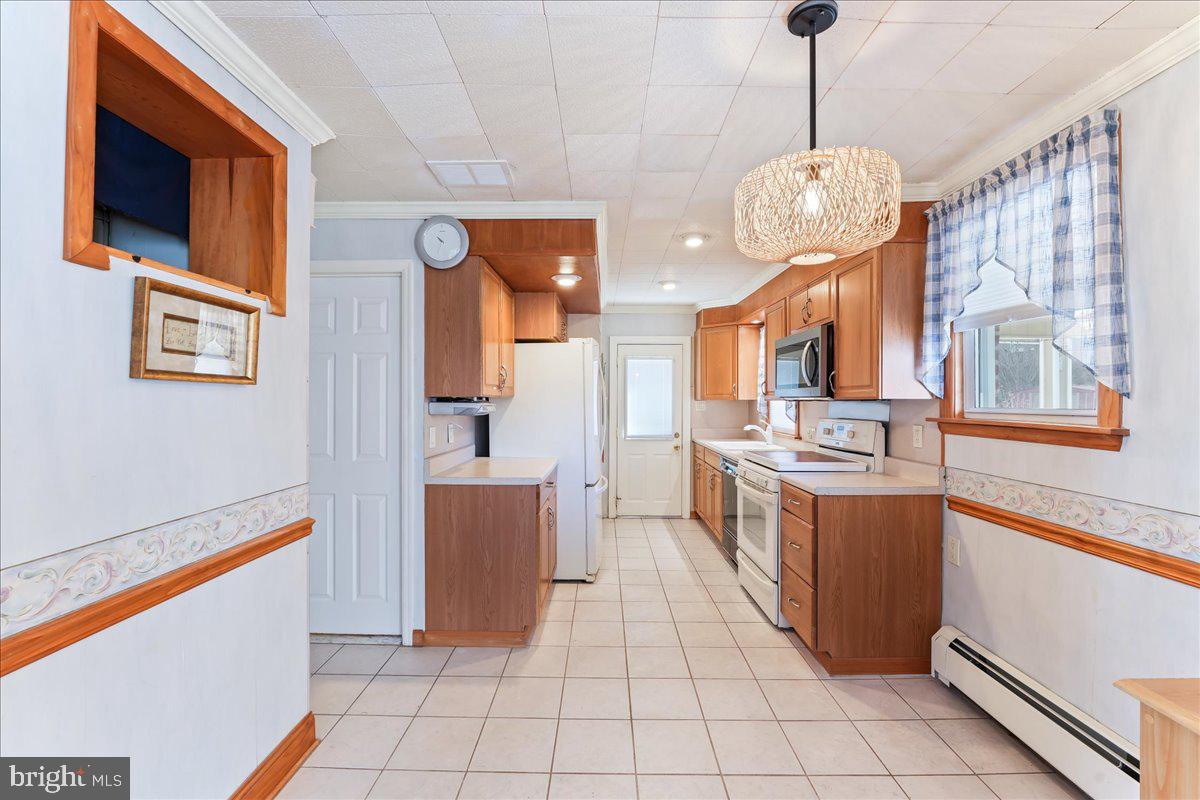 1449 Burmont Road Drexel Hill, PA 19026 - Photo 9 of 27 a kitchen with stainless steel appliances granite countertop a refrigerator and a stove top oven