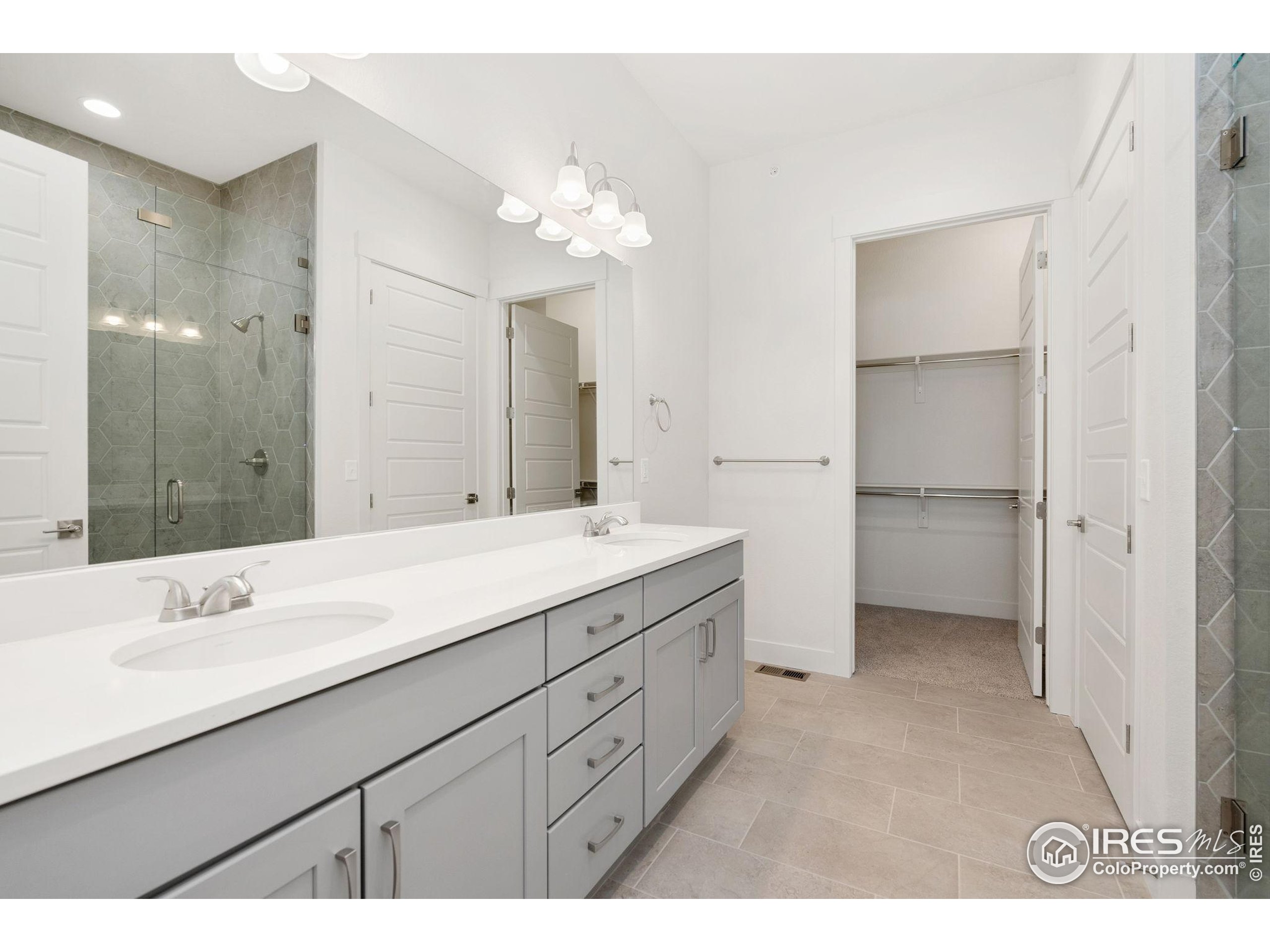 2978 Fleet Drive, Unit 4 Fort Collins, CO 80524 - Photo 13 of 17 a bathroom with a double vanity sink and a mirror