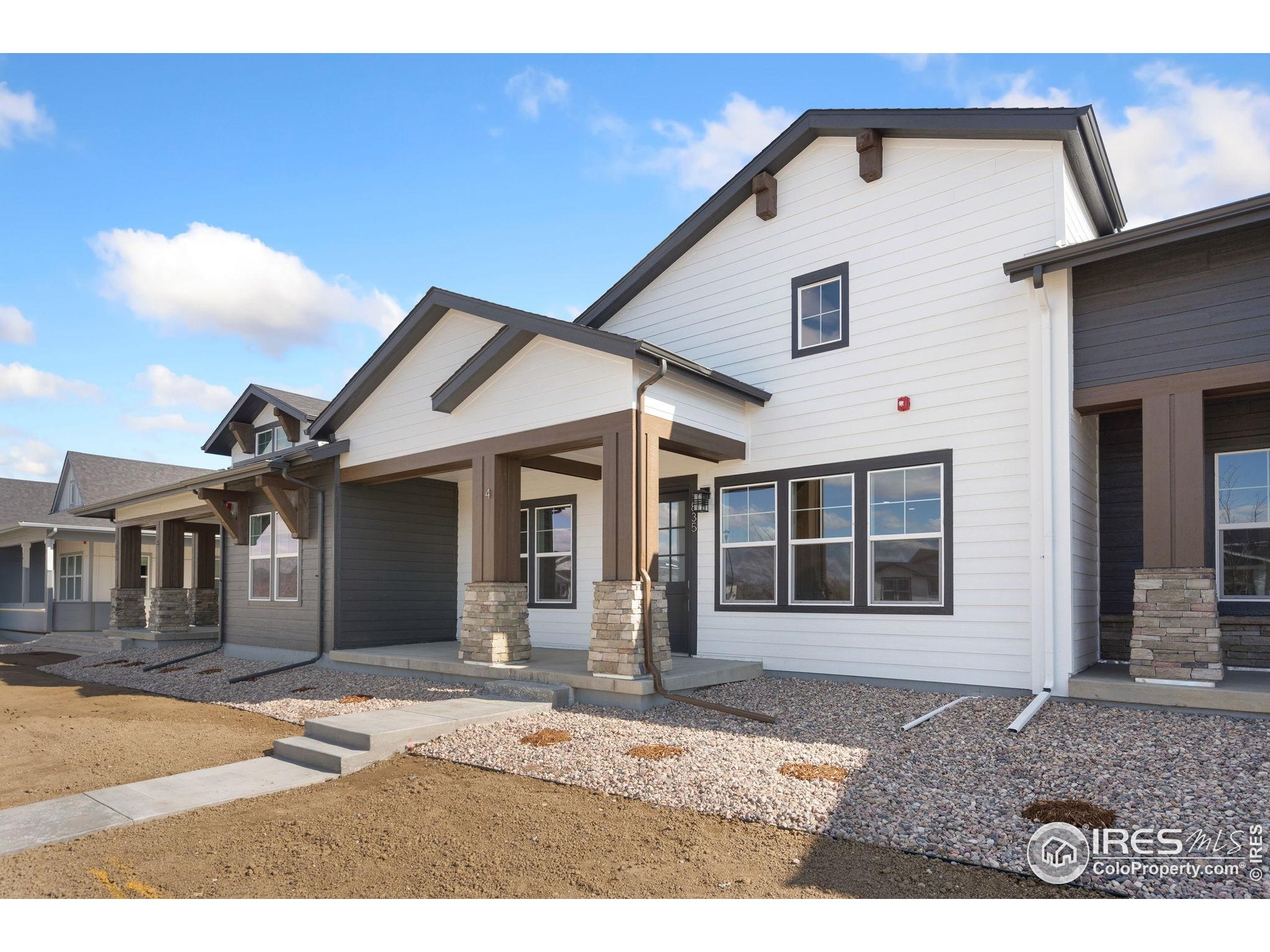 2978 Fleet Drive, Unit 4 Fort Collins, CO 80524 - Photo 2 of 17 a front view of a house with a porch