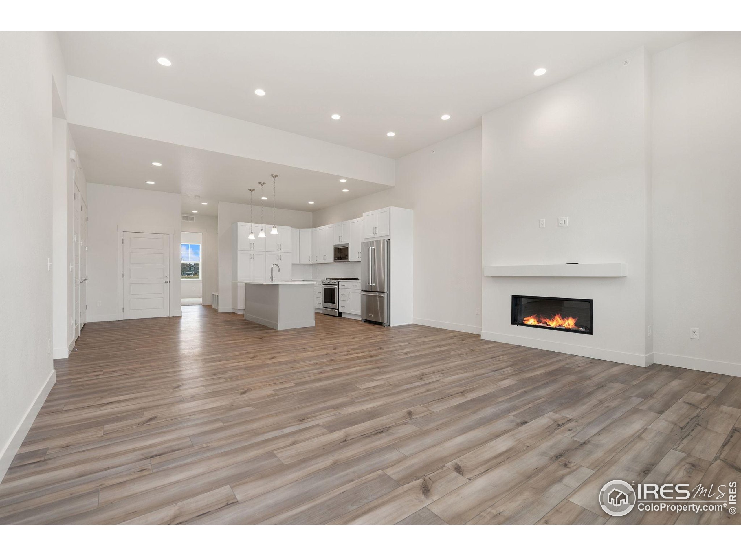 2978 Fleet Drive, Unit 4 Fort Collins, CO 80524 - Photo 3 of 17 a view of an empty room and a kitchen