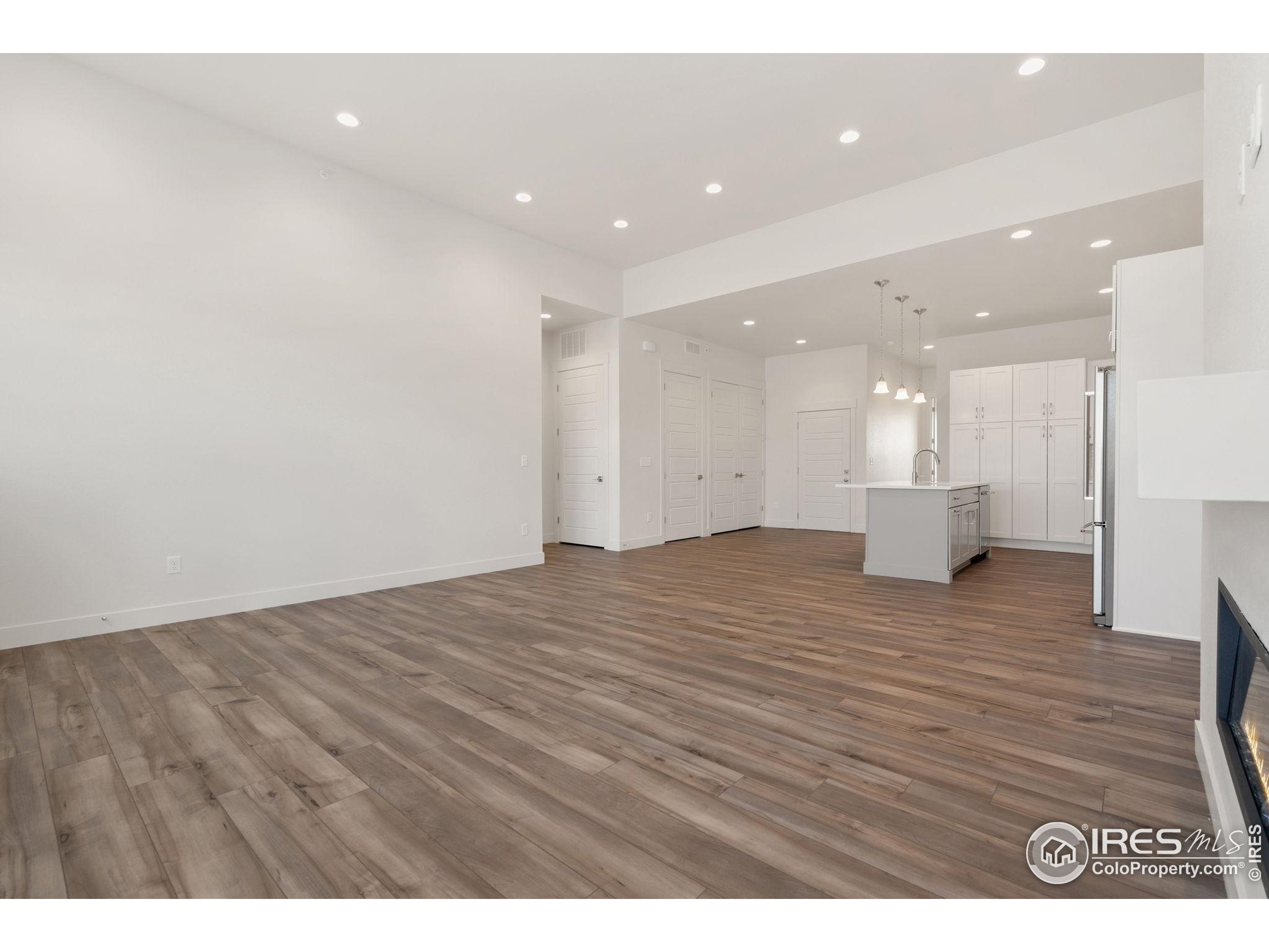 2978 Fleet Drive, Unit 4 Fort Collins, CO 80524 - Photo 5 of 17 a view of an empty room with wooden floor