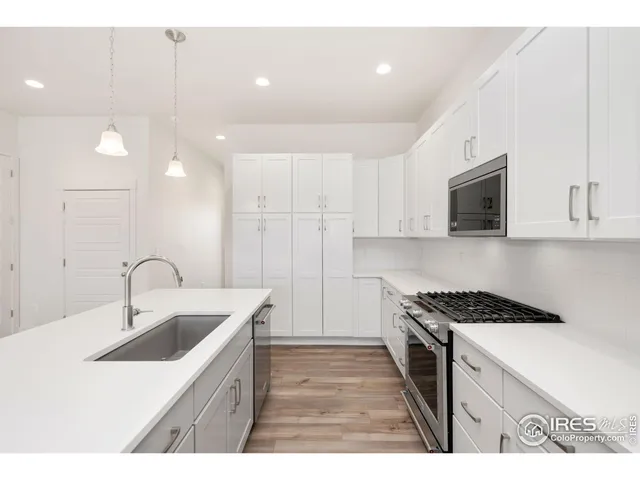 a kitchen that has a sink and a stove