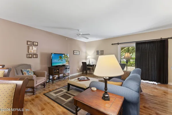a living room with furniture and a wooden floor