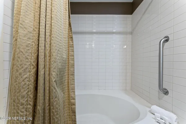 a bedroom with furniture and a large window