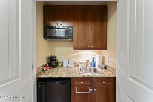 a living room with a sink and a mirror
