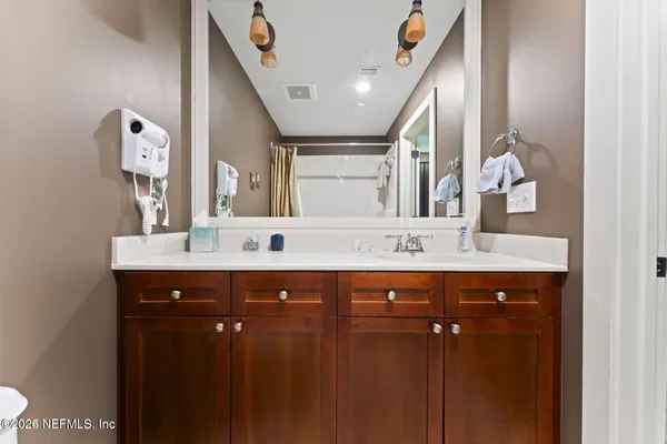 a front view of a house with garden and plants