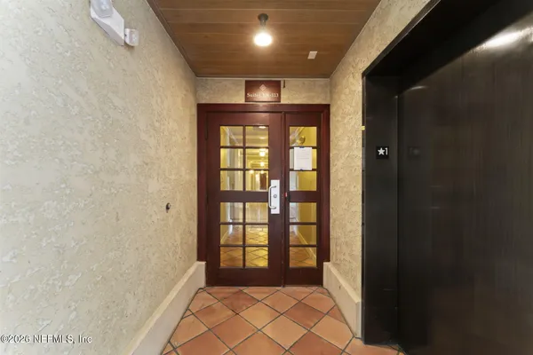a view of a hallway with workspace and entryway