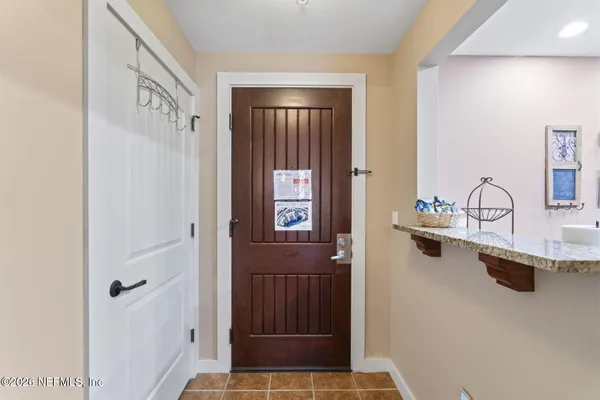 a living room with furniture a chandelier and a dining table