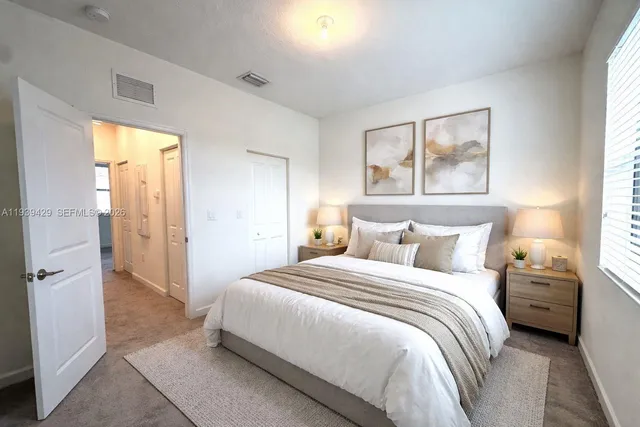 a bedroom with a bed and a painting on the wall