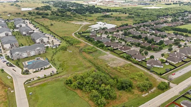 an aerial view of residential houses with outdoor space and river