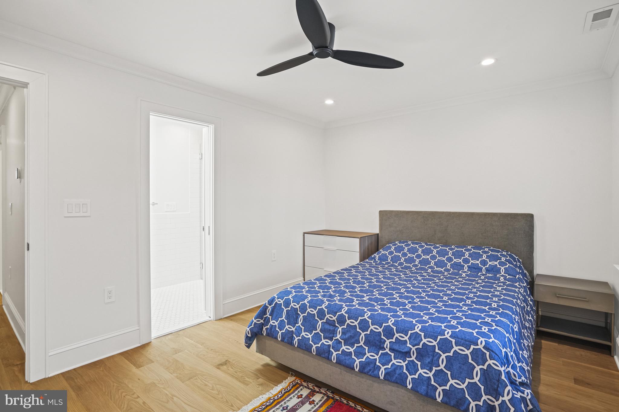 1920 35th Street Northwest Washington, DC 20007 - Photo 19 of 53 a bedroom with a large bed and a chandelier