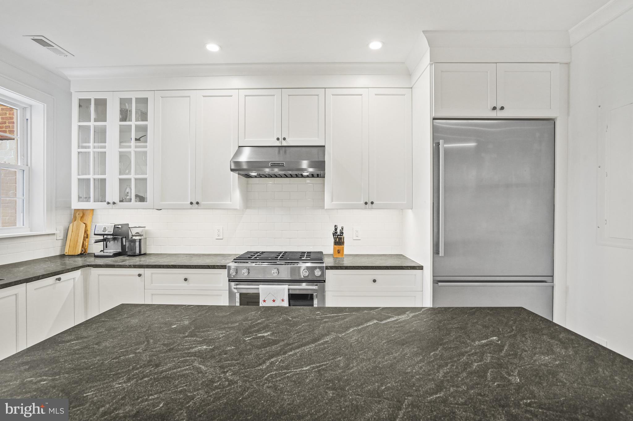 1920 35th Street Northwest Washington, DC 20007 - Photo 3 of 53 a kitchen with stainless steel appliances granite countertop a refrigerator and a stove top oven